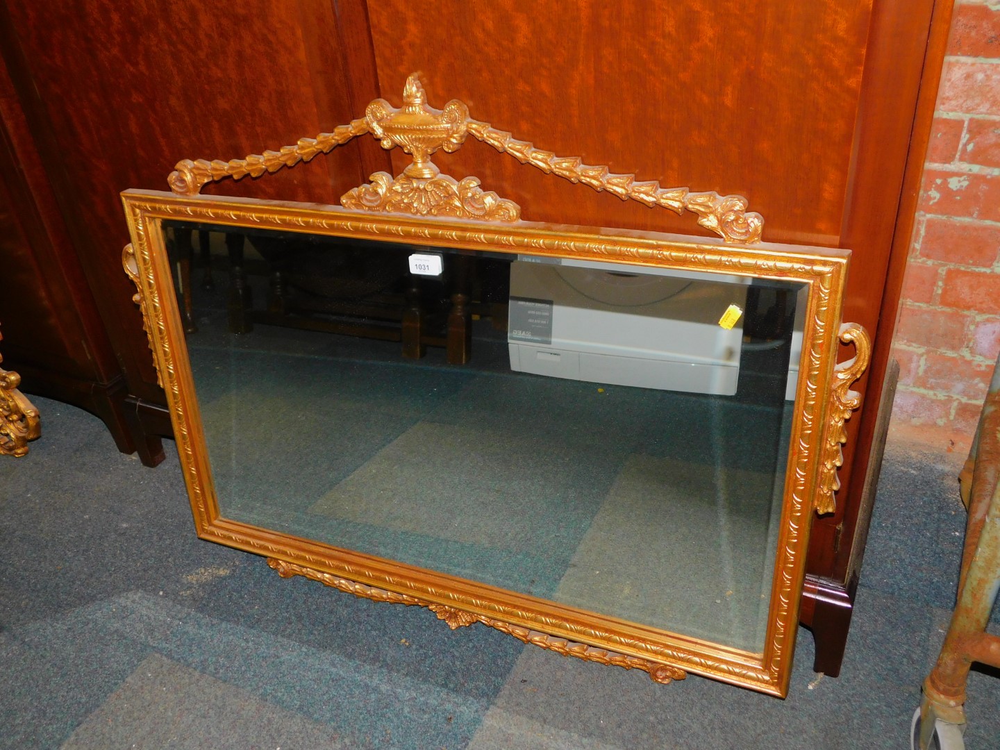 An Adam style gilt framed overmantel mirror, with bevelled plate, 98cm x 77cm.