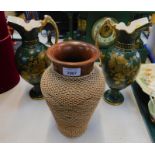 A cane bound earthenware jar, together with a pair of Victorian gilt decorated green ewers. (3)