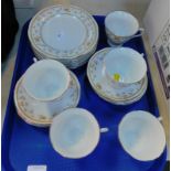 A Chinese porcelain part tea service, decorated with sprigs of flowers, comprising six cups, saucers