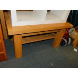 An oak coffee table, with lower tier, raised on square block legs, 49cm high, 90cm wide, 61cm deep.