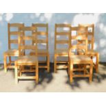 A set of six beech ladder back dining chairs, with solid seats.