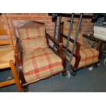 A pair of early 20thC mahogany bergere armchairs, upholstered in tartan fabric.