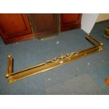 A Victorian brass fender, with scroll decoration and galleried top, 164cm max length, 132cm min