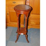 A reproduction mahogany plant stand, with barley twist supports and an under tier, 77cm high.