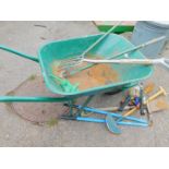 A garden wheelbarrow, containing a quantity of hand tools. (a quantity)