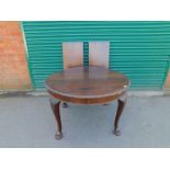 An Edwardian Chippendale style mahogany wind-out dining table, with two additional leaves, raised on