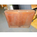 A 19thC mahogany wall cupboard, enclosing a single shelf, with brass carrying handles to each