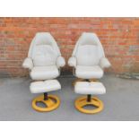 A pair of cream leather Stressless arm chairs, with matching stools. (4)