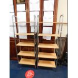 A pair of chrome framed free standing shelving units, each with five beech effect shelves.