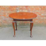 A Victorian mahogany occasional table, with a fluted oval top, raised on cabriole legs, 73.5cm high,