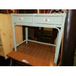 A bamboo and wicker dressing table, with two drawers having glass handles, painted in mint green,