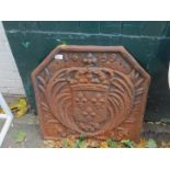 A cast iron fire back, marked 1669, decorated with a family crest of a shield with crown aloft and