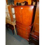 A Shaw of London mahogany drinks cabinet, above brushing slide and four drawers, raised on bracket