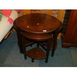 A circular oak quintetto of occasional tables, raised on square legs, 52cm high, 61cm diameter.