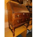 A 20thC oak bureau, with fitted interior above two drawers, 107cm high, 77cm wide, 50cm deep.