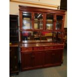 A mahogany display cabinet above a mirror back sideboard, four drawers over four cupboard doors