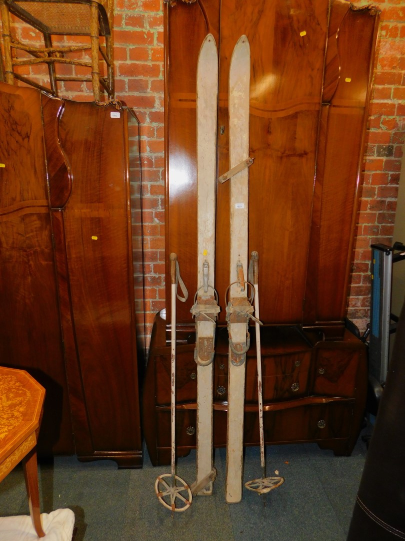 A pair of painted wooden ski's, 209cm long, with Northland boot attachments, and two matching