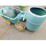 A garden water butt, garden barrow, child's garden barrow, various garden netting, wire, etc.,