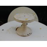 A white painted cast iron potter's wheel or rotating stand, 22cm high, 25cm diameter.