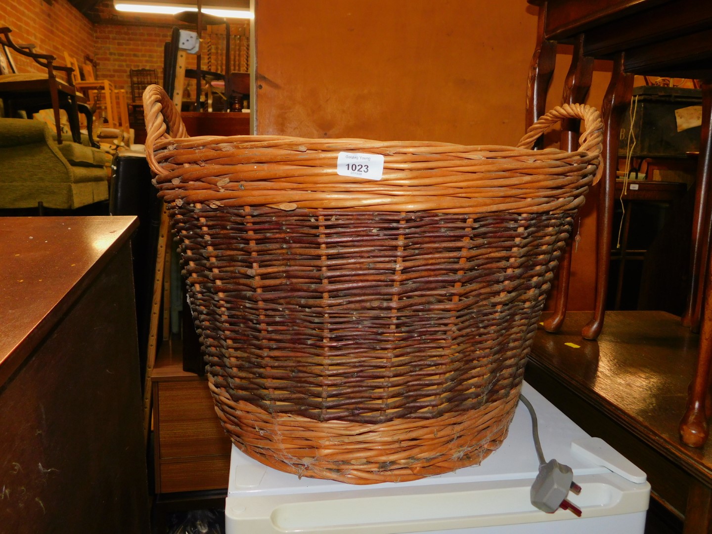 A wicker basket, with two handles and darker central band decoration, 40cm high, 53cm diameter.