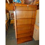 An oak laminate bookcase, enclosing five adjustable shelves, 184cm high, 91cm wide, 31cm deep.