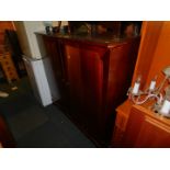 A large reproduction mahogany television cabinet, with lower compartment, 123cm high, 125cm wide,