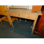 An early 20thC pine lowboy or side table, with single drawer, raised on square tapering legs, 73cm