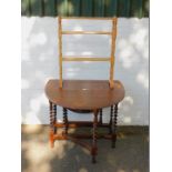 An oak drop leaf table, 75cm high, 38cm wide, 132cm extended, 90cm deep., together with a towel