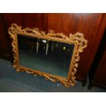 A rococo style gilt framed overmantel mirror, with bevelled plate, 100cm x 75cm.