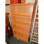 A beech laminate bookcase, enclosing four adjustable shelves, 161cm high, 80cm wide, 30cm deep.