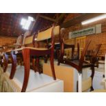 A set of four reproduction mahogany dining chairs, with yellow draylon upholstery. The upholstery in