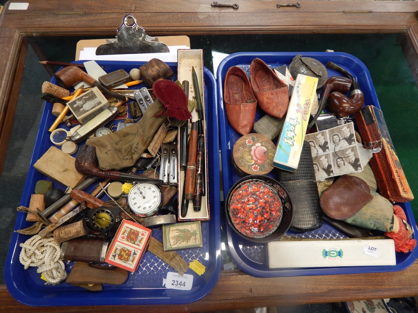 Vintage pens, briar wood pipes, an Ingersoll stopwatch and sundry collectables. (2 trays)