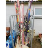 Skies and poles, including Atomic Super Cross, Kastle, Fischer, etc. (a quantity)