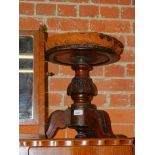 A Victorian mahogany revolving piano stool, brown leather upholstery over a turned and carved