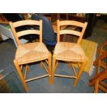 A pair of beech and rush seated bar chairs, 97cm high.