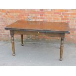 A stained oak draw leaf dining table, raised on turned legs, 78cm high, 146cm wide, 246cm