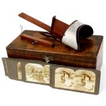 An early 20thC stereoscopic viewer, with a number of cards in oak case, cards to include Before