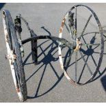 An unusual iron barrel cart, with two large spoke wheels and horse shoe centre section, with