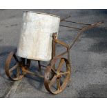 A late 19th/early 20thC mobile bran tub, with rotating cylindrical centre section on a wrought