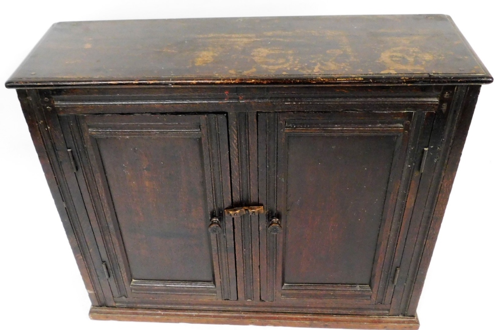 An late 17thC oak two door cupboard, with two panel doors, 103cm wide. - Image 2 of 3