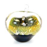 A 20thC Our Glass apple, in gilt black and green colour way, dated 2011, 9cm high.