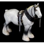 A Beswick grey shire horse, with leather style tack, printed marks beneath, 20cm high.