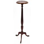 An early 20thC mahogany plant stand, the circular top raised on a reeded stem, terminating in triple