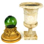 A marble centrepiece urn, of campana form with drop scroll border, partially gadrooned on a square