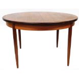 A vintage G Plan extending dining table, of circular form on turned tapering legs, (when closed)