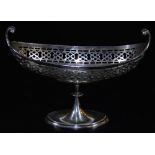 A George V silver dish, of boat shape with a partially pierced upper repeat border, on an inverted