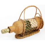 A Vintage bottle of Moet and Chandon champagne, in a wicker carafe, 89cm high.