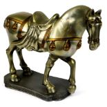 A Chinese Tang design metal figure of a horse, in standing pose on a shaped base with Greek key