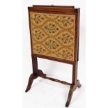 A late 19thC mahogany fire screen, with adjustable top and sides with embroidered front on saber