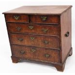 A George III style walnut chest, of two short and three long graduated cock beaded drawers, each